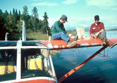 Bruce Conant and Jim King taking a lunch break on top of wing of N754. Photo: USFWS