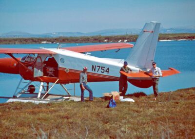 N754 on shore of a lake in the Old Crow Flats, Yukon Territory, with (left to right) Bruce Conant, Mort Smith (FWS Chief Pilot and head of Continental Surveys), and Jim King, 1979. Photo: USFWS